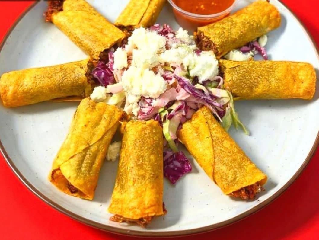 Crispy flautas with crema and cotija.